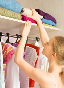 woman chooses clothes in the wardrobe closet at home